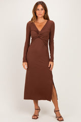 woman wearing a brown long sleeve maxi dress with a twist front and a side slit