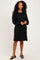 woman wearing a black long sleeve ribbed dress with a relaxed fit and balloon sleeves