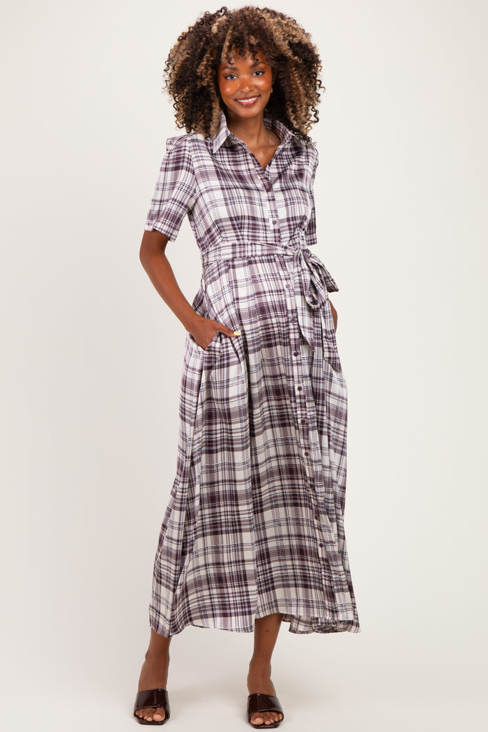 woman wearing a purple and white plaid maternity maxi dress with short sleeves and a tie waist, showing her baby bump