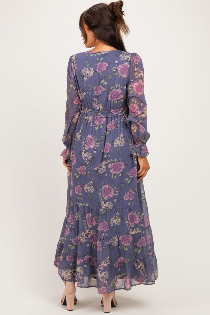 woman wearing a floral maternity maxi dress with long sleeves and a tiered skirt, showcasing a relaxed fit