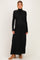 woman wearing a black long sleeve maternity maxi dress with a mock turtleneck and a visible baby bump