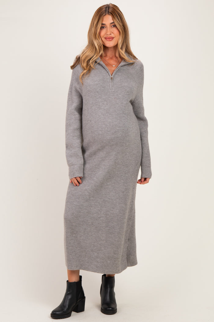 woman wearing a gray long sleeve maternity sweater dress with a collar and a visible baby bump