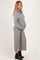 woman wearing a gray ribbed zip-up maternity dress and showing her baby bump