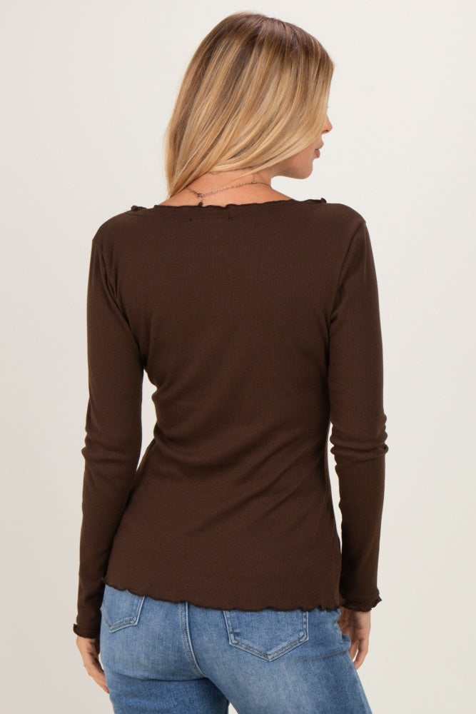 woman wearing a brown long sleeve top with a scalloped neckline and back view, paired with blue jeans