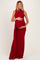 woman wearing a red sleeveless maternity gown with ruching, displaying her baby bump