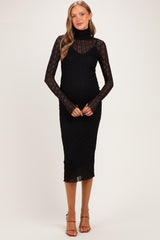 woman wearing a black ribbed long sleeve maternity dress with a turtleneck and a visible baby bump