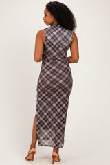 woman wearing a sleeveless plaid maxi dress with a high slit and open back, shown from the back