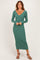 woman wearing a long sleeve green ribbed midi dress with a v-neckline and styled with strappy heels