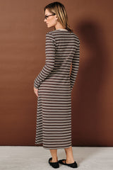 woman wearing a brown and beige striped long sleeve maxi dress, showing the back view