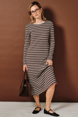 woman wearing a long sleeve brown striped midi dress with a scoop neckline and black flats, holding a brown bag