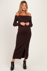 woman wearing a brown off-shoulder ribbed maternity dress with button details and a visible baby bump
