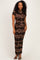 woman wearing a form-fitting brown floral lace gown with short sleeves and a sheer overlay
