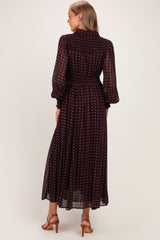 woman wearing a burgundy polka dot maternity dress with long sleeves and a cinched waist, seen from the back