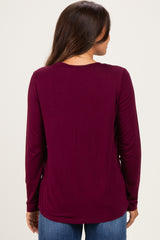 woman wearing a long sleeve maternity top in dark burgundy, shown from the back