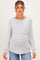 woman wearing a light gray long sleeve maternity top with a scoop neckline and visible baby bump