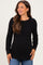 woman wearing a black long sleeve maternity top with a fitted bodice and relaxed hemline, smiling