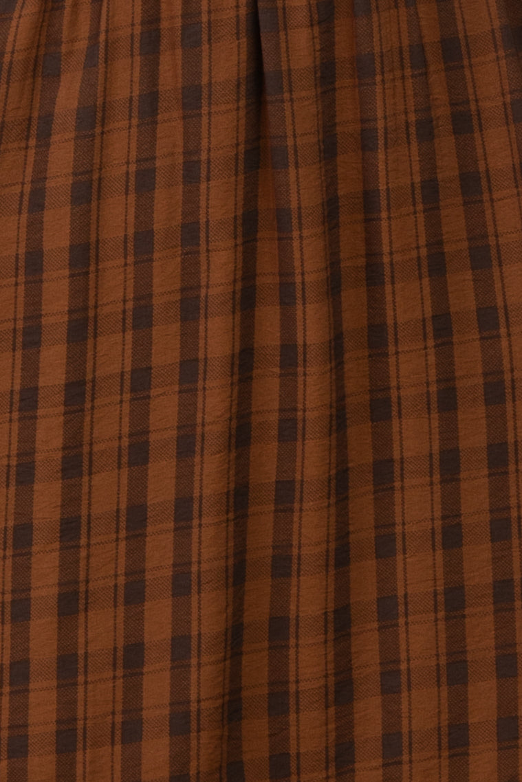 brown plaid midi skirt with a gathered waistline and soft fabric texture