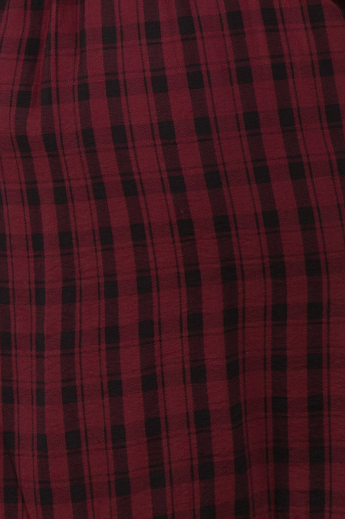 red and black plaid fabric, close-up view showing a textured pattern
