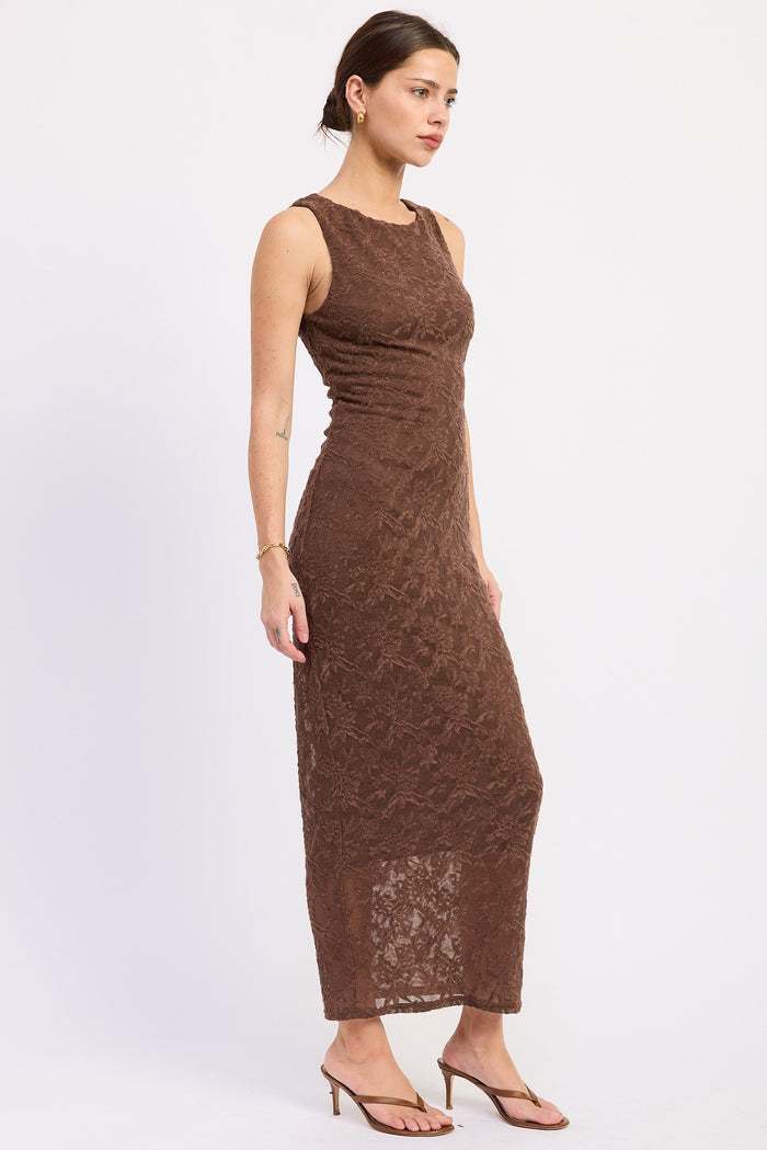 woman wearing a brown lace maxi dress with a fitted bodice and a long skirt, paired with strappy heels