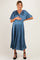 woman wearing a teal pleated maternity dress with flutter sleeves and holding her baby bump