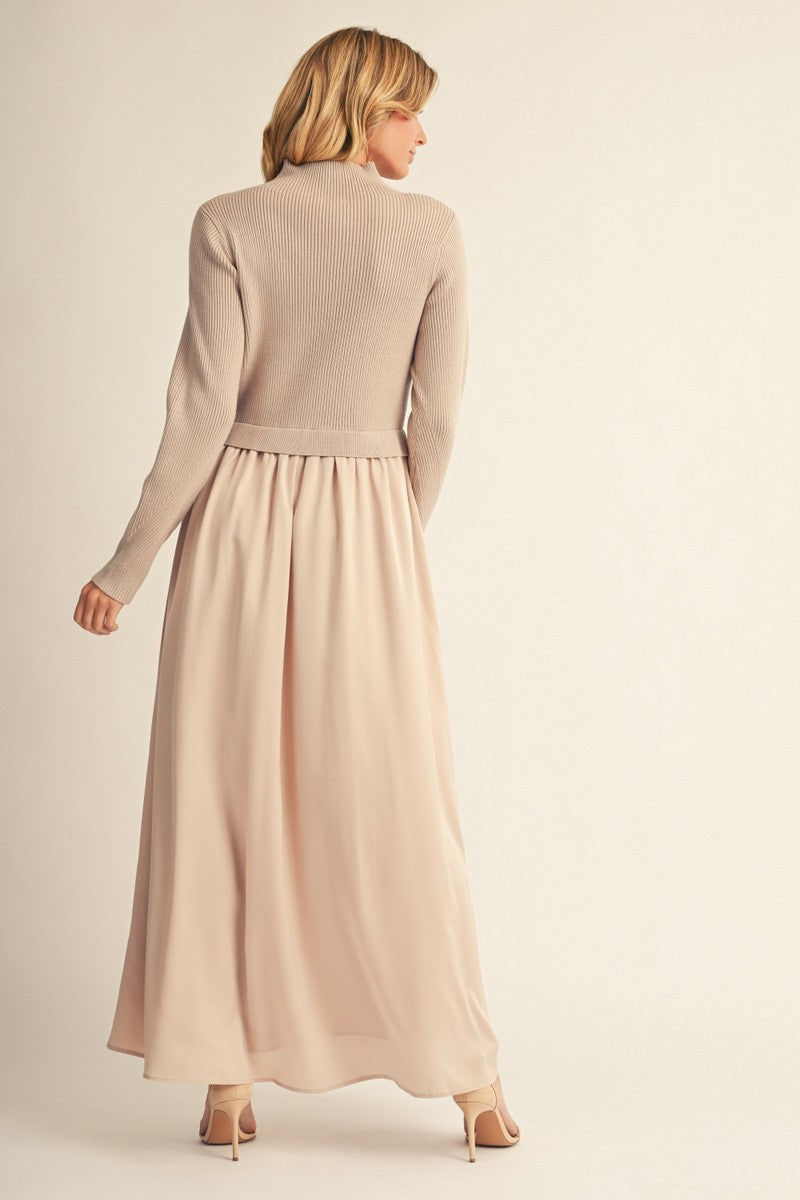 woman wearing a beige long sleeve knitted sweater with a flowy light pink maxi skirt