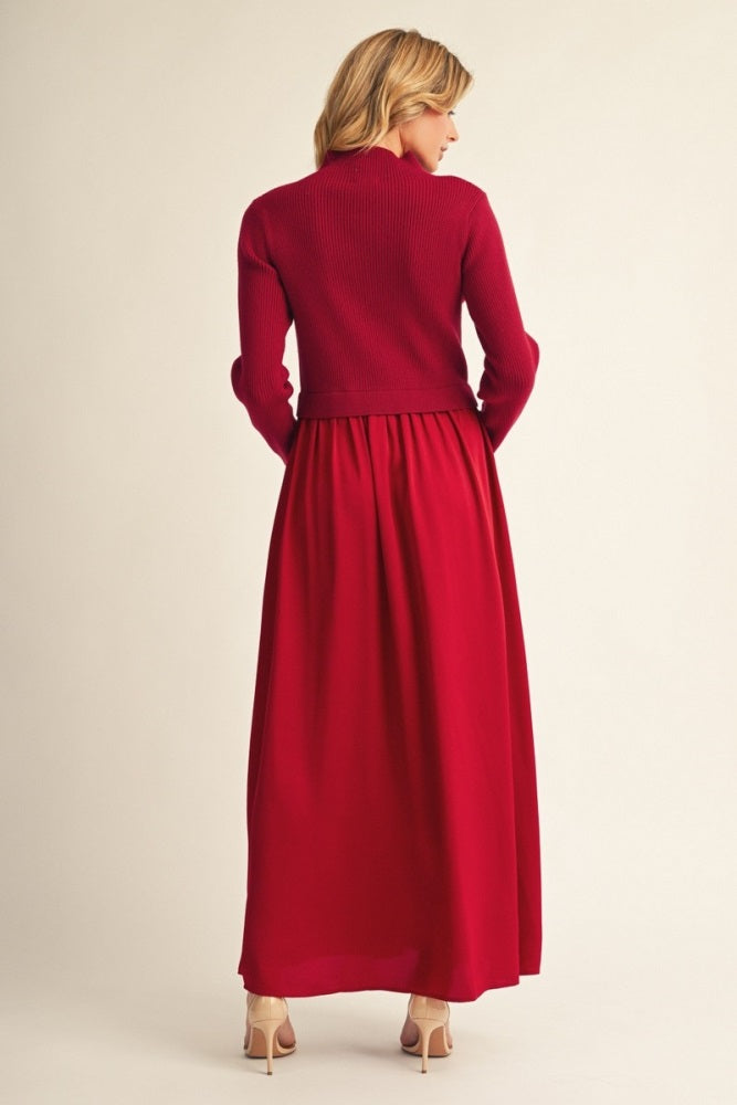 woman wearing a red long sleeve sweater and a red maxi dress, viewed from the back