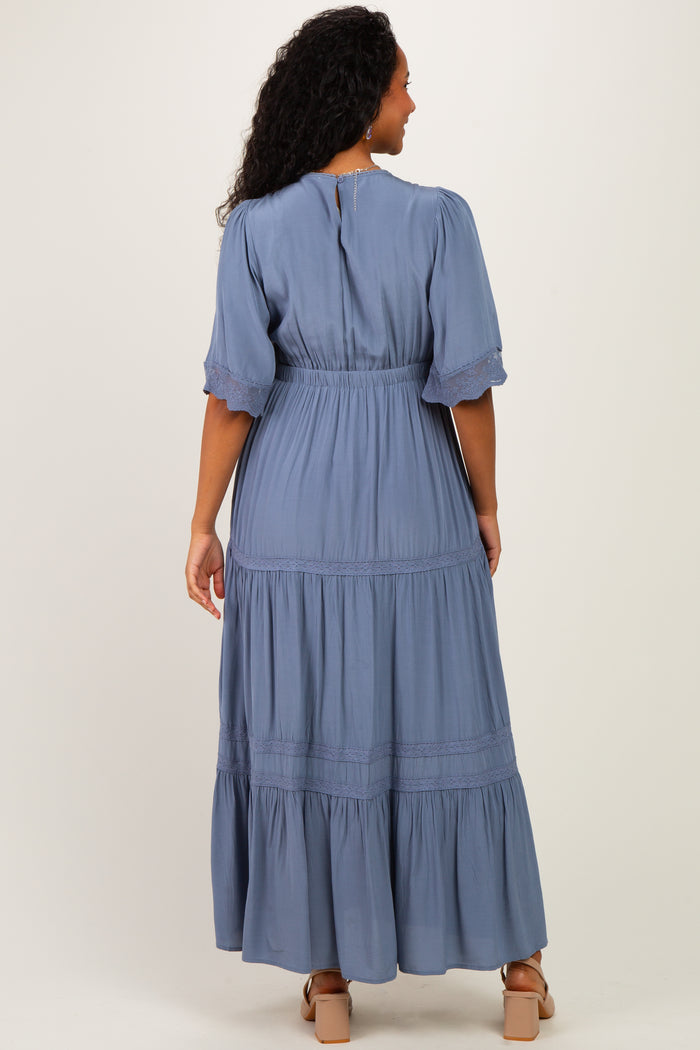 woman wearing a light blue maternity maxi dress with short sleeves and tiered ruffled hem