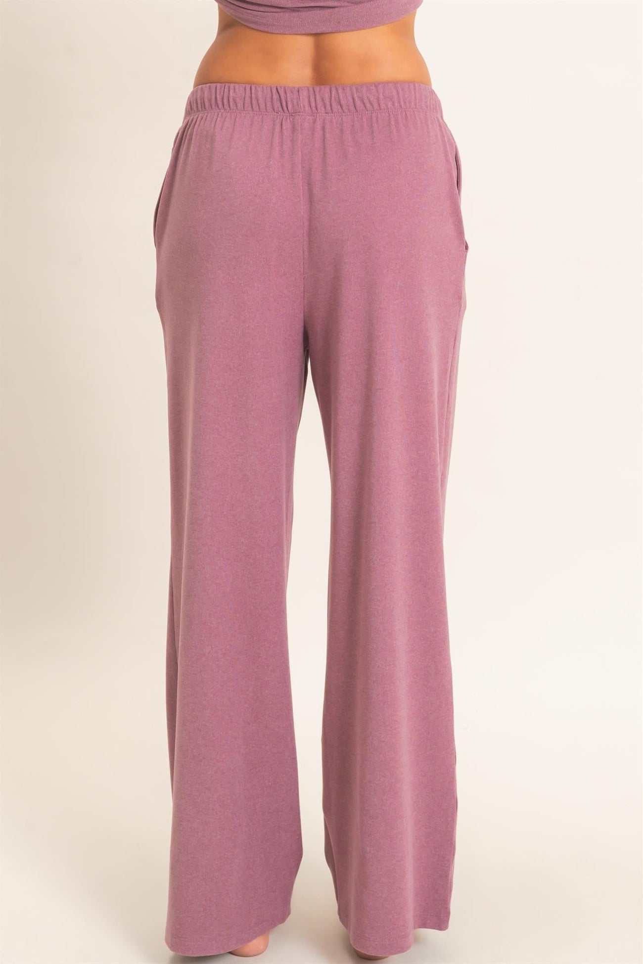 woman wearing relaxed fit light pink wide-leg lounge pants with pockets
