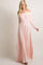 woman wearing a light pink off-the-shoulder maxi dress with long sleeves and a fitted bodice