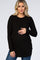 woman wearing a black long sleeve maternity top and holding her baby bump