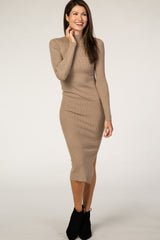 woman wearing a beige ribbed long sleeve midi dress and black ankle boots