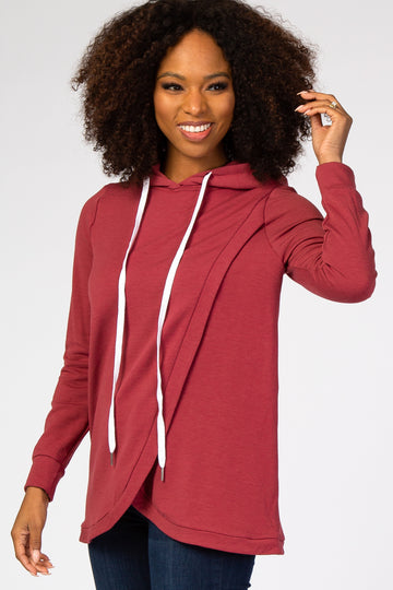 woman wearing a maroon long sleeve hoodie with a draped front and white drawstrings