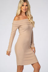 woman wearing a ribbed off-the-shoulder beige dress with long sleeves and a fitted silhouette