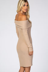 woman wearing a fitted beige ribbed off-the-shoulder dress with long sleeves, styled elegantly from the back