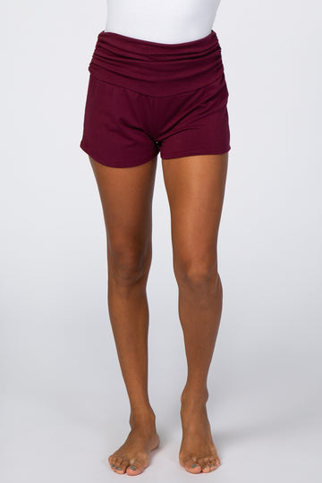 woman wearing burgundy lounge shorts with a ruched waistband and a relaxed fit