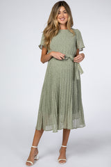 woman wearing a green floral print maternity dress with short sleeves and a tie waist detail