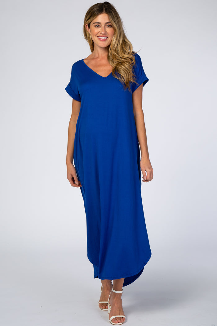 woman wearing a bright blue short sleeve maxi maternity dress with a v-neckline and relaxed fit