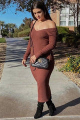 woman wearing a rust-colored ribbed off-the-shoulder midi dress with black knee-high boots and a crossbody bag
