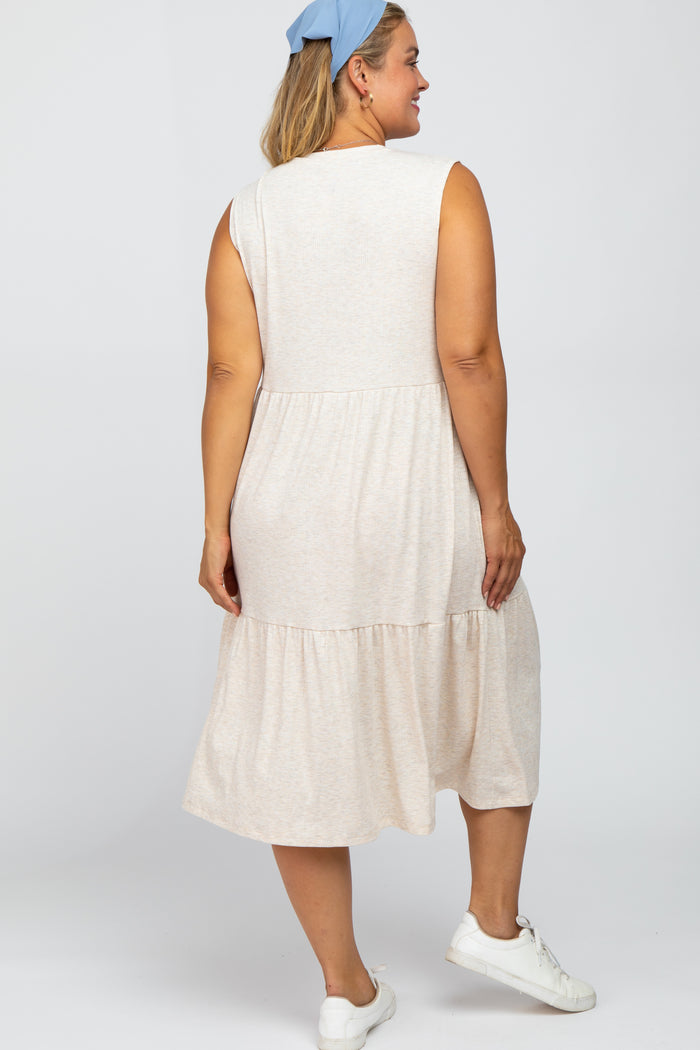 Back view of a woman wearing a sleeveless cream tiered midi dress and white sneakers