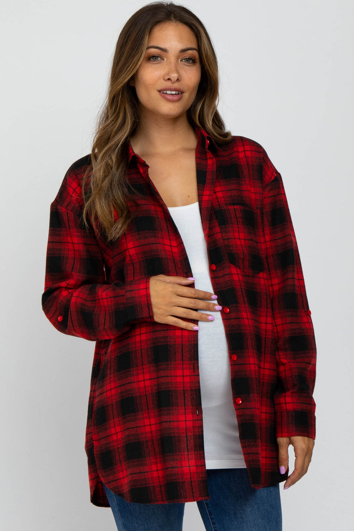 woman wearing a red and black plaid maternity shirt and holding her baby bump