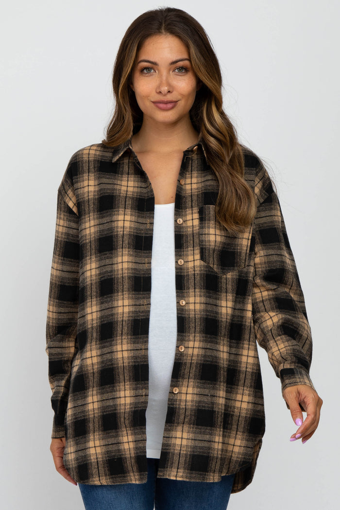 woman wearing a black and tan plaid maternity shirt with a white tank top underneath and a visible baby bump