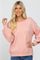 blonde woman wearing a light pink long sleeve knit sweater with balloon sleeves and a boat neckline