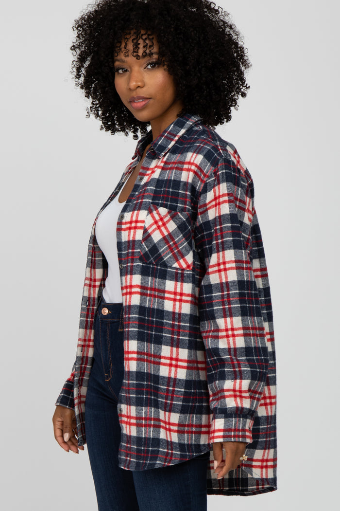 Woman with curly hair wearing a red, white, and blue plaid flannel shirt over a white top and jeans