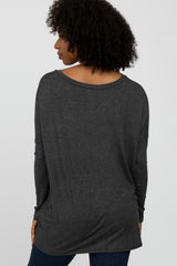 woman wearing a dark gray oversized long sleeve top, viewing from the back, styled with loose fit and dropped shoulders