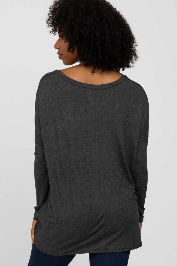 woman wearing a dark gray oversized long sleeve top, viewing from the back, styled with loose fit and dropped shoulders