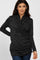 woman wearing a dark grey long sleeve wrap top with gathered detail, styled with blue jeans