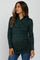 woman wearing a dark green long sleeve maternity top with a wrap design and ruching, showing her baby bump