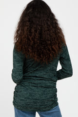 woman wearing a dark green long sleeve top with gathered detailing at the sides, seen from the back