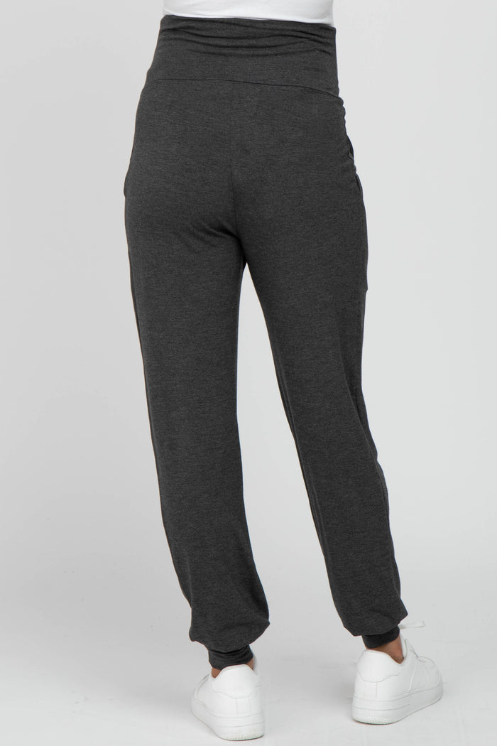 woman wearing dark gray maternity joggers with a high waistband, viewed from the back