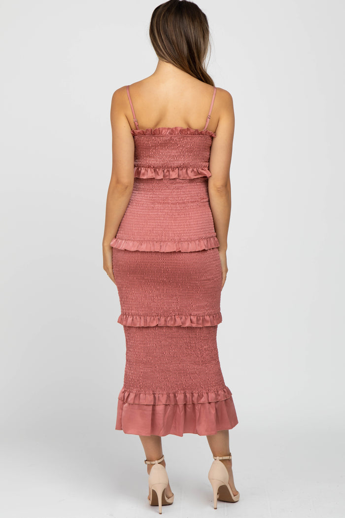 back view of woman wearing a mauve smocked tiered midi dress with ruffle details and beige high heels
